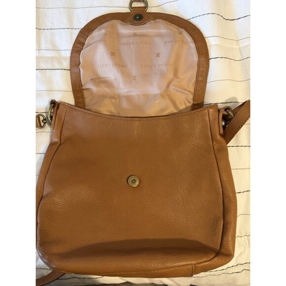 Lucky Brand | Ali Cognac Pebble Leather Flap Crossbody Saddle Bag Tan Tassel - Picture 9 of 12